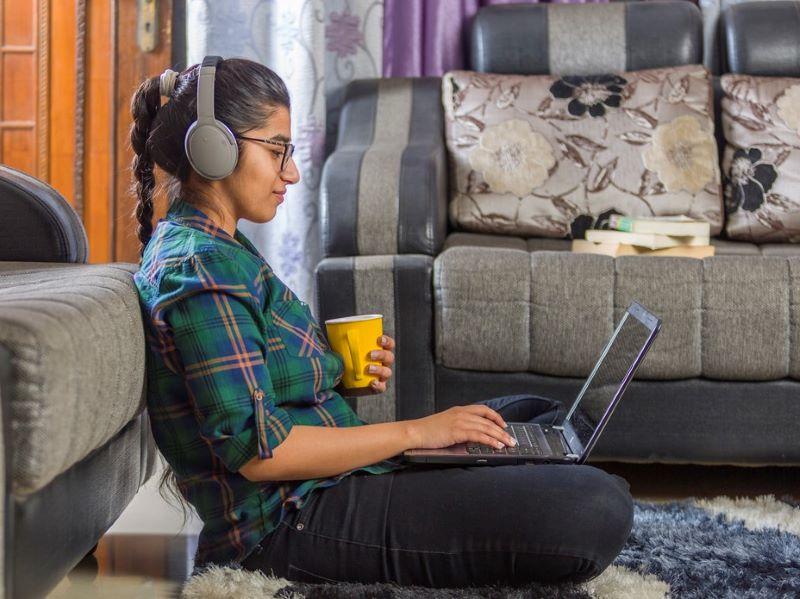 A student watching a lecture online at home