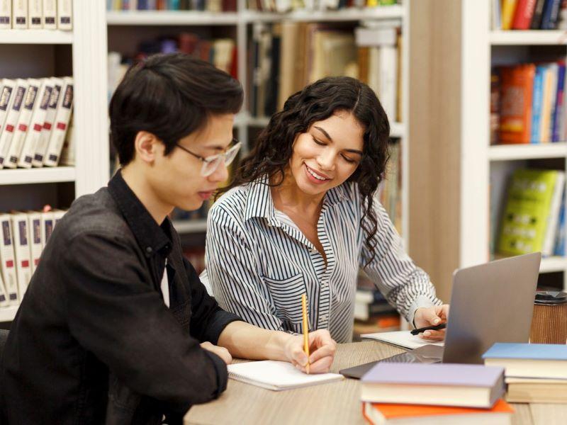 Two tutors discussing marks on a paper