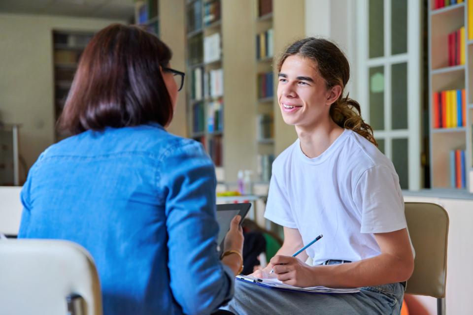 A male student sitting talking to an advisor