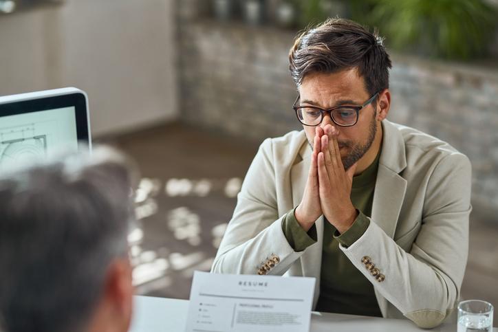 Young man having stressful job interview