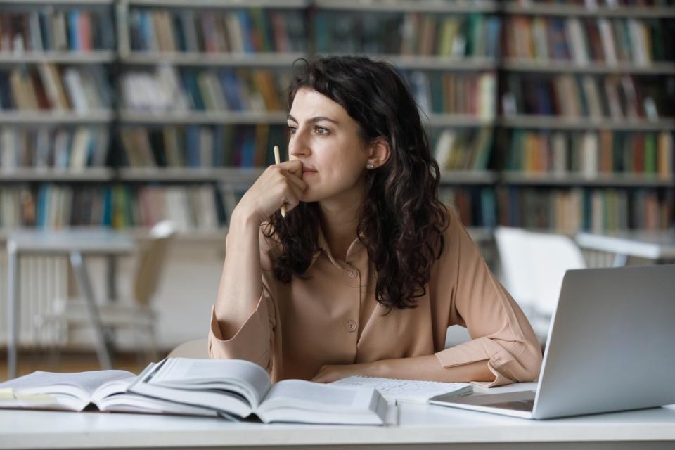 Student thinking at her desk