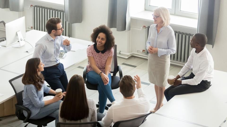 Teacher explaining concepts to a group of students