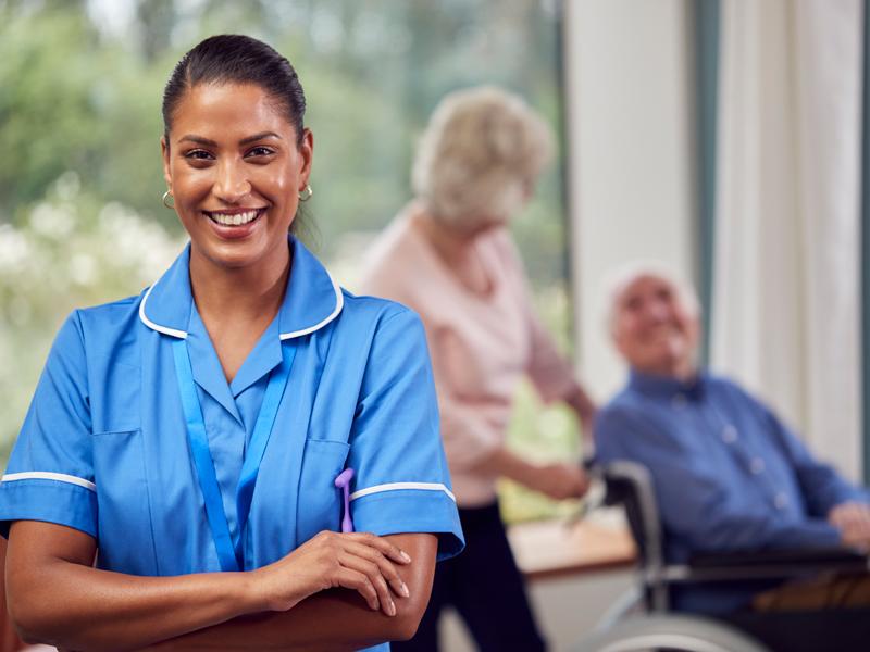 Social worker stands with two older patients