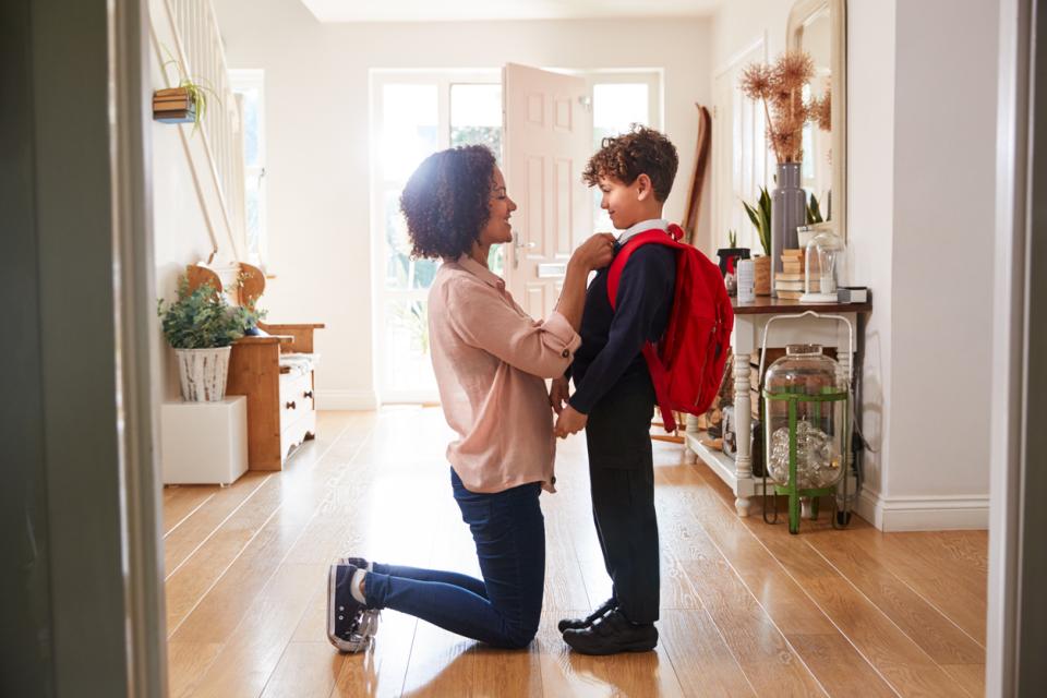 Mother getting her son ready for school