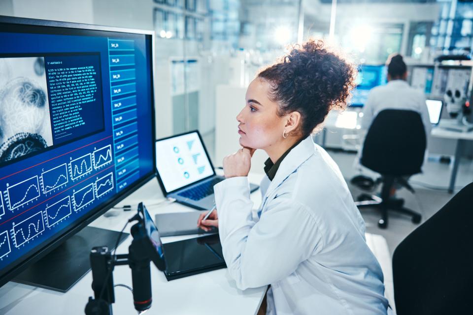 A researcher in a lab looking at her computer