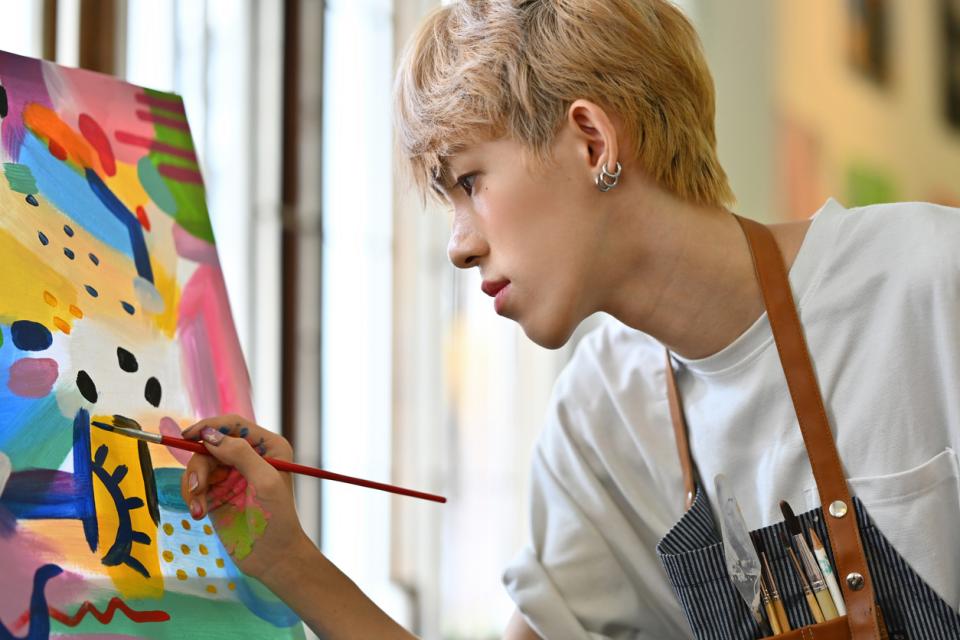 A student painting on a canvas