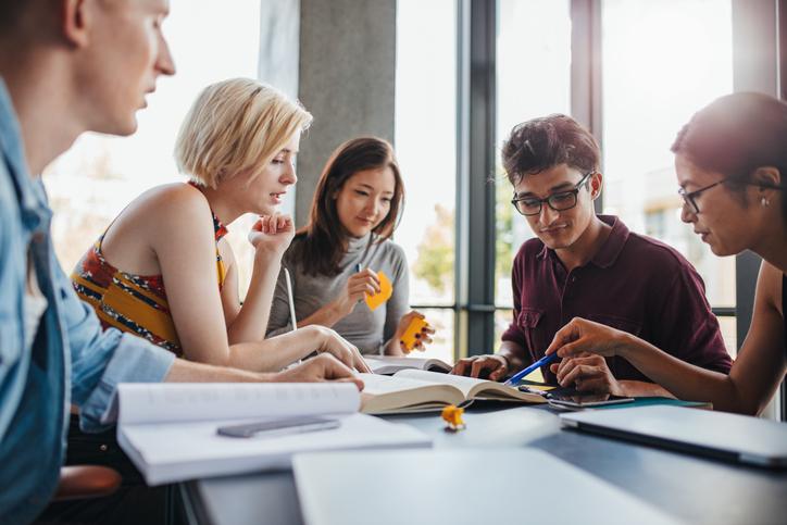 Academics work together around a table