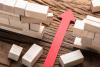 red arrow through a wall of wooden blocks