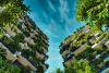 Two skyscrapers covered in plants