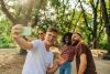 Multiracial group of students taking a selfie in the park